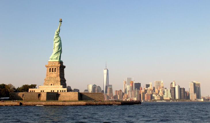 The green Statue of Liberty seen from Staten Island, with the Manhattan, New York skyline seen in background