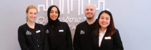 Group photo of the team at Queensboro Plaza Dental Care in Long Island City