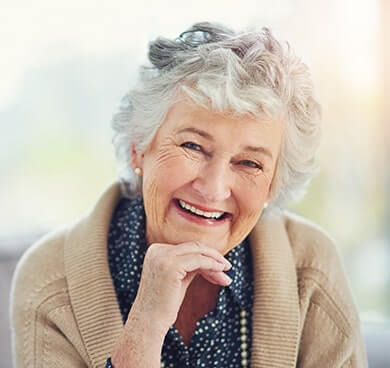 Smiling older woman loving her new dentures