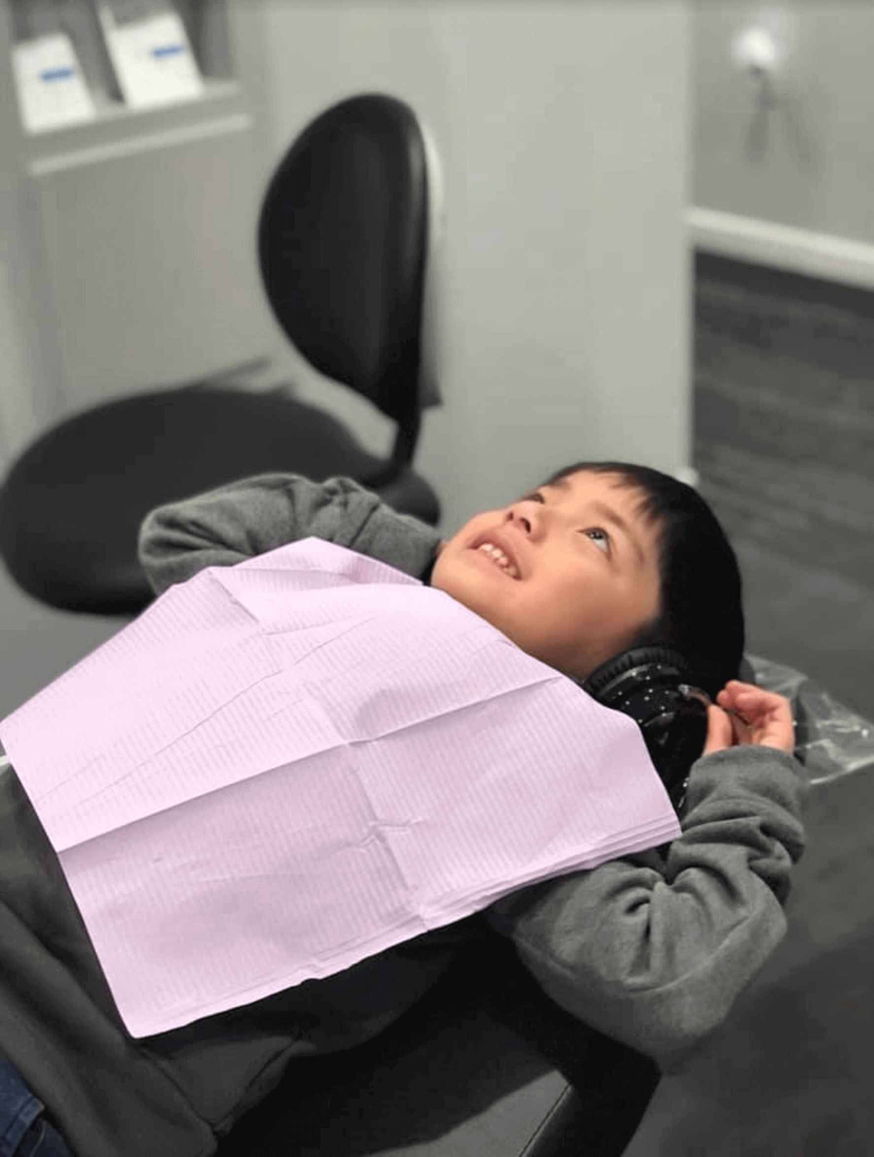 Young child sitting in the dental chair waiting for his appointment