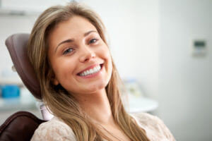 Brunette young woman smiles as she prepares to get her wisdom teeth removed