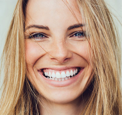 Woman smiling after teeth whitening