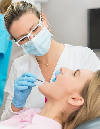 woman having her teeth examined by her dentist