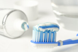 Toothbrush loaded with fluoride toothpaste for cavity prevention.
