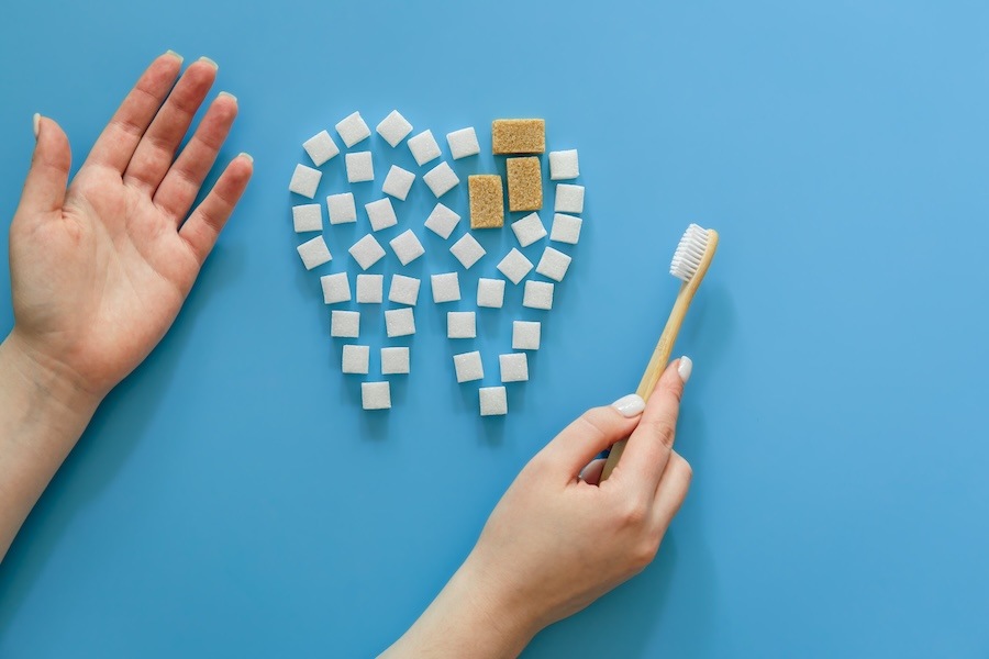 flat graphic of white and brown sugar cubes made into a tooth to show sugar and tooth decay,  protect teeth from sugar, dentist Long Island City, Queensboro Plaza Dental Care