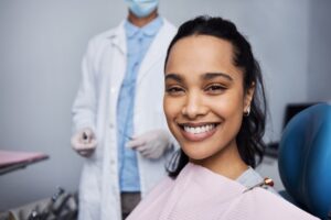 woman in dental chair for broken veneer
