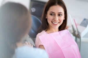 woman talking with dental provider about restorative dentistry and cosmetic dentistry