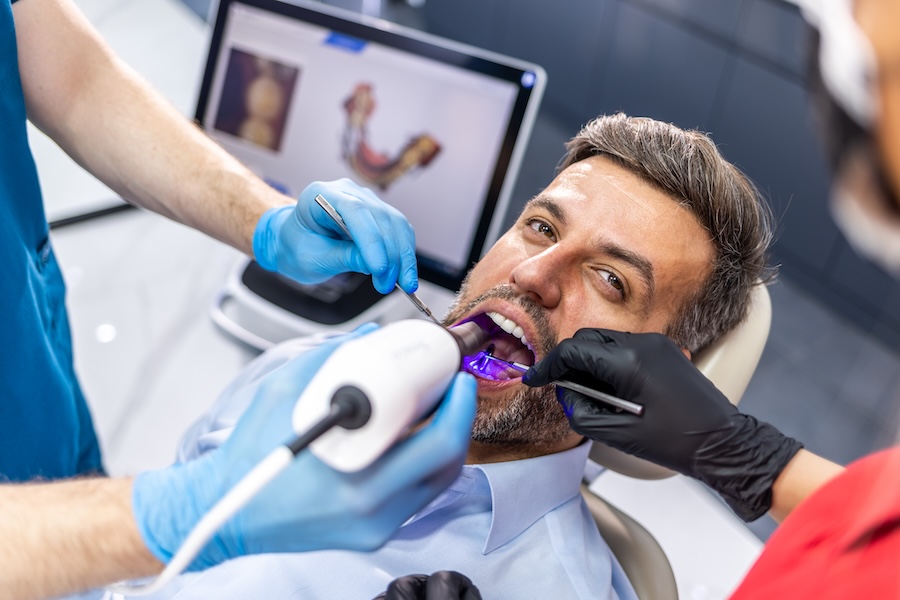 man getting digital impressions for crowns or clear aligners