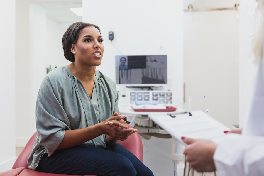 extraction or root canal, patient discussing it at the dentist
